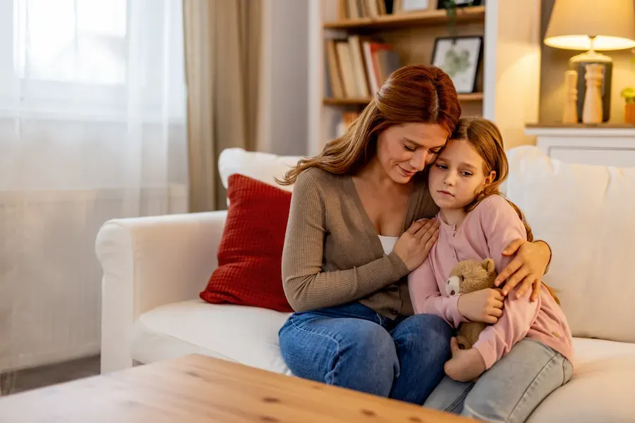 A mother and her daughter sitting together